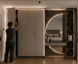 Fitter making final adjustments to fitted bedroom furniture